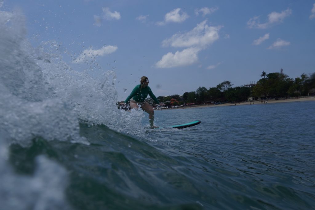 Gentle, clean blue waves breaking offshore at a beginner-friendly nusa dua surf spots reef break in Bali.
