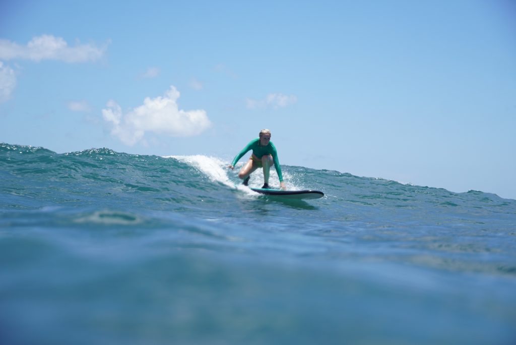 Bingin beach surf lessons - Surf Journey Bali-1 An intermediate surfer mastering the reef during expert bingin beach surf lessons in Bali.