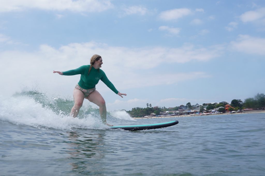 Jimbaran Muaya Bay - Surf Journey Bali A learner enjoying one of the best bali surf spots for beginners at Muaya Beach Jimbaran Bay, Bali