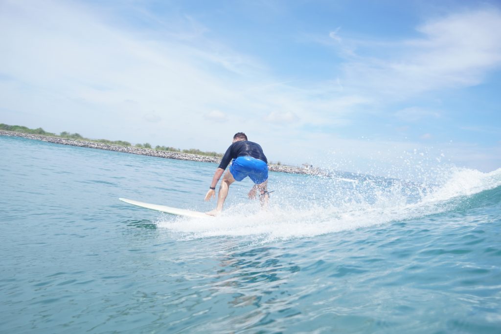 Men reach a great progress of surf at Kelan Beach (Jimbaran Bay)