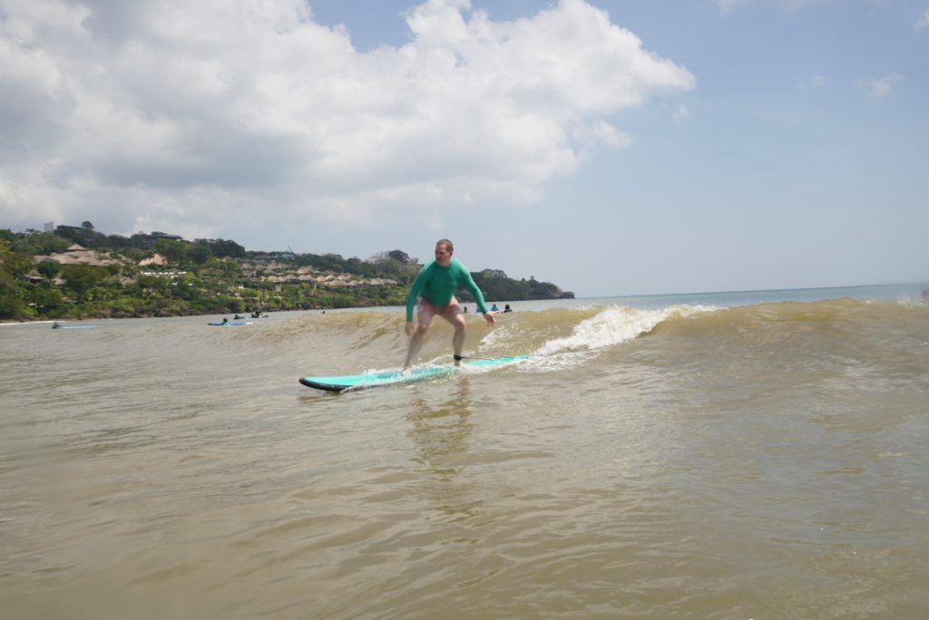 Man enjoy Surf Journey Bali surf lesson in Muaya Beach, Jimbaran, Bali