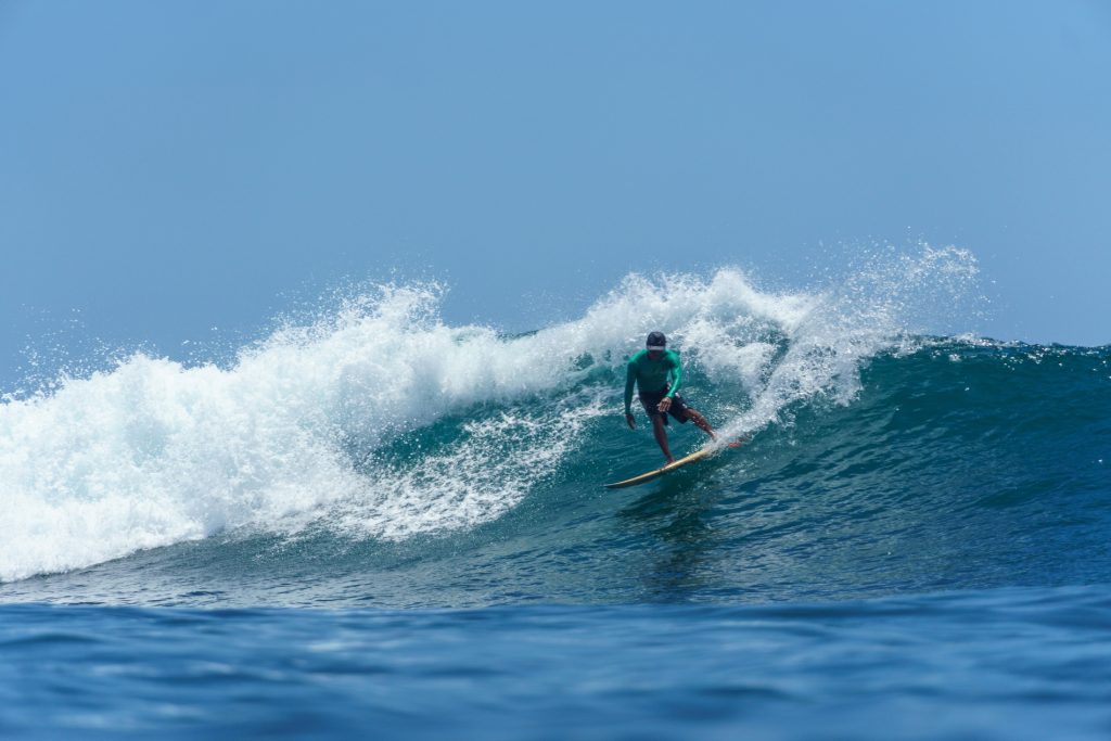 The Bukit Peninsula Surf - Surf Journey Bali A Surf Journey Bali coach performs dramatic surf moves at Balangan Beach.