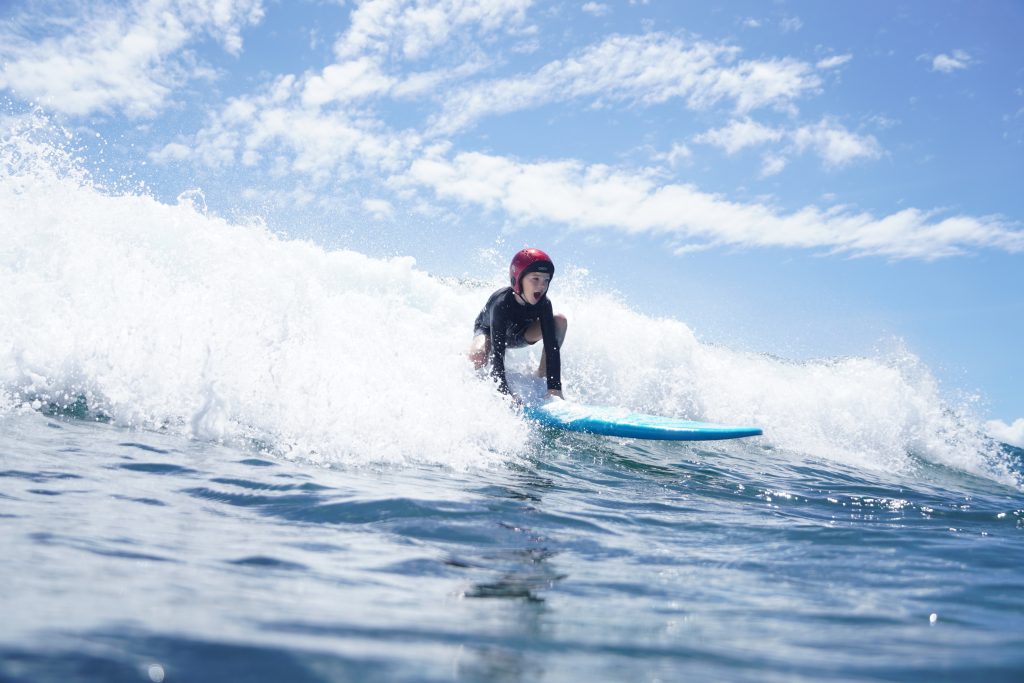 Kids have fun on gentle wave at Uluwatu, Balangan, Bali