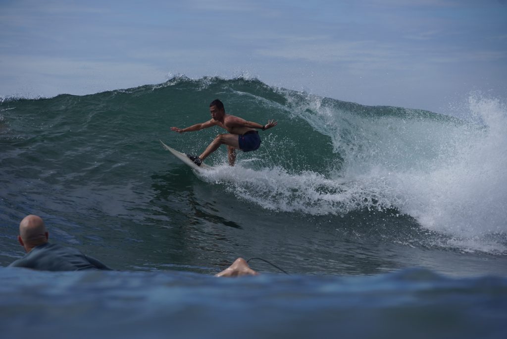 Men enjoying sturdy waves of Balian surf spots
