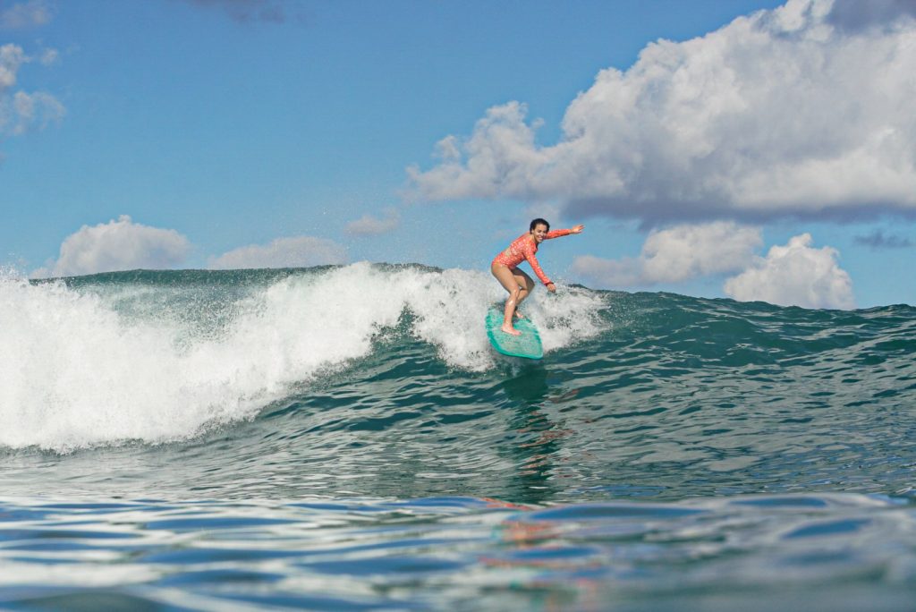 Standing up on green waves Woman standing on green waves with Surf Journey Bali sessions