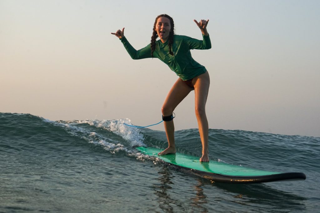 Woman have a fun surf sessions with Surf Journey Bali at Batu Bolong Beach