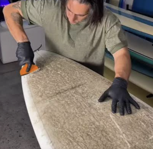 scraping the surfboard